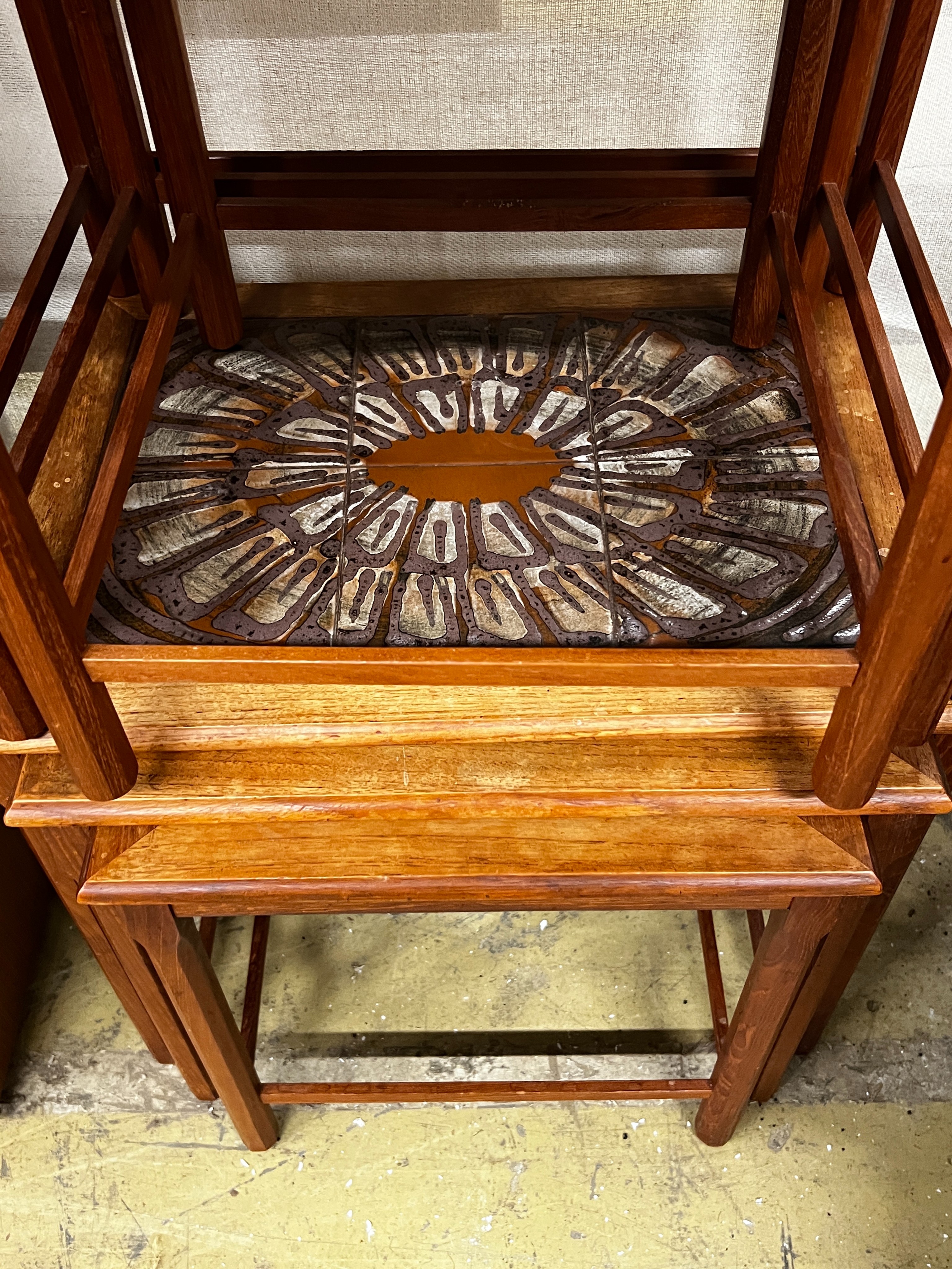 Two mid century tiled top teak nests of tables by Toften Mobelfabrikken, Denmark, width 55cm, depth 40cm, height 47cm